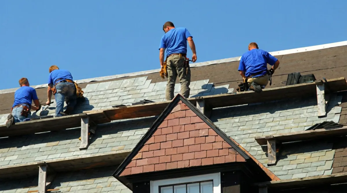 Roof replacement in progress with a team of professional contractors installing new shingles on a residential home in Yonkers, NY